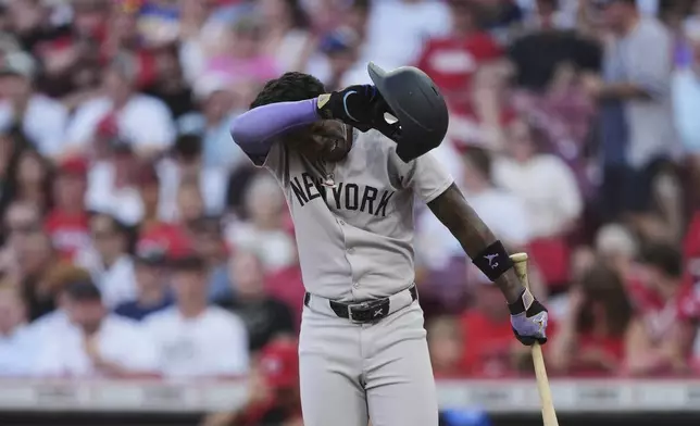 New York Yankees' Jazz Chisholm Jr. wipes his his face during the third inning pauses of a baseball game against the Cincinnati Reds, Monday, June 23, 2025, in Cincinnati. (AP Photo/Joshua A. Bickel)