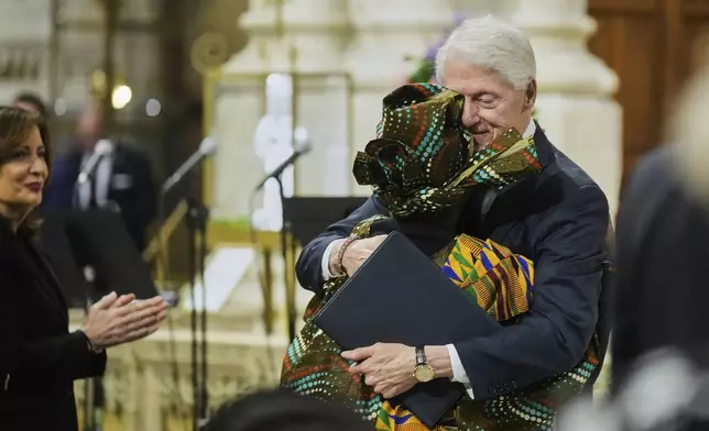 Former President Bill Clinton is embraced' after he spoke during the funeral for former Rep. Charles Rangel, D-N.Y., at New York's St. Patrick's Cathedral, Friday, June 13, 2025. (AP Photo/Richard Drew)