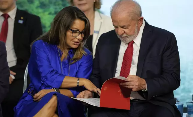 FILE - Brazil's President Luiz Inacio Lula da Silva and first lady Rosangela da Silva attend a ceremony at the Itaipu hydroelectric dam on the shared border with Paraguay, in Foz do Iguaçu, Brazil, March 16, 2023. (AP Photo/Jorge Saenz, File)