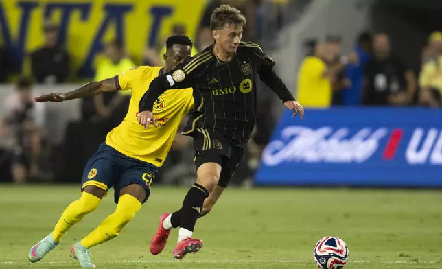 Los Angeles FC forward Nathan Ordaz, right, dribbles the ball away from Club América defender Cristian Borja during the first half of a FIFA Club World Cup play-in soccer match Saturday, May 31, 2025, in Los Angeles. (AP Photo/Kyusung Gong)