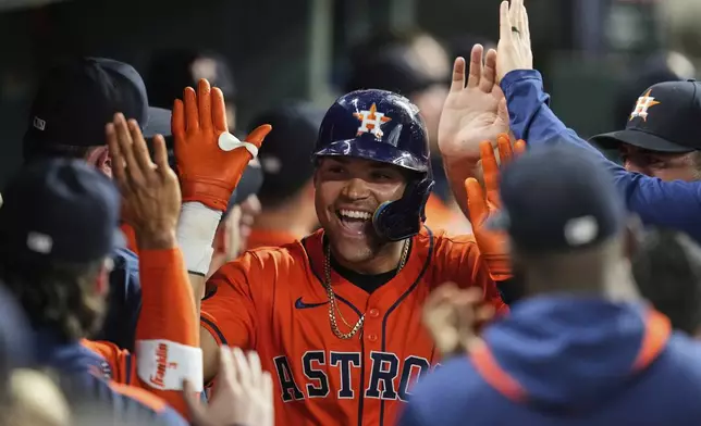 Houston Astros' Cam Smith celebrates in the dugout after hitting a home run during the fourth inning of a baseball game against the Chicago Cubs in Houston, Friday, June 27, 2025. Isaac Paredes and Jose Altuve also scored. (AP Photo/Ashley Landis)