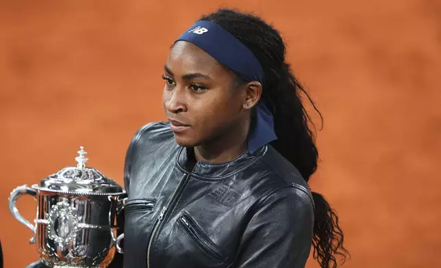 Coco Gauff of the U.S. holds the trophy while being interviewed after winning the final match of the French Tennis Open against Aryna Sabalenka of Belarus at the Roland-Garros stadium in Paris, Saturday, June 7, 2025. (AP Photo/Lindsey Wasson)