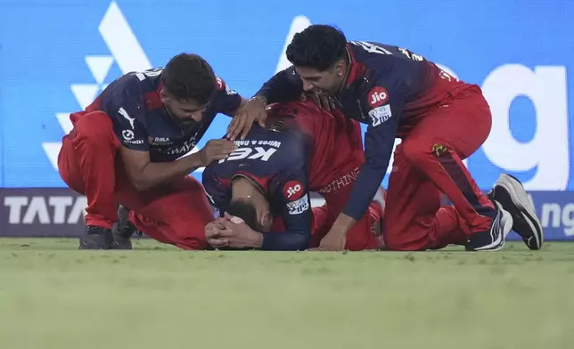 Royal Challengers Bengaluru's Virat Kohli, center, reacts after their win in the Indian Premier League final cricket match against Punjab Kings at Narendra Modi Stadium in Ahmedabad, India, Tuesday, June 3, 2025. (AP Photo/Ajit Solanki)
