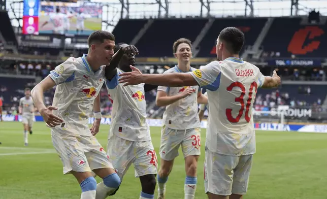 Red Bull Salzburg's Oscar Gloukh, right, celebrates with teammates after scoring his side's opening goal during the Club World Cup group H soccer match between CF Pachuca and FC Salzburg in Cincinnati, Wednesday, June 18, 2025. (AP Photo/Jeffrey Dean)