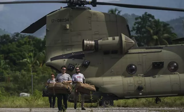 FILE - Team Rubicon's disaster response members unload aid at the airport following a 7.2 magnitude earthquake, in Les Cayes, Haiti, Aug. 19, 2021. (AP Photo/Fernando Llano, File)