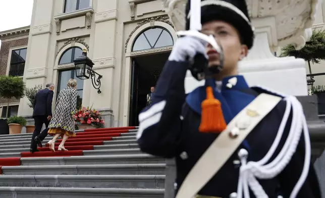 Canada's Prime Minister Mark Carney and his wife Diana, left, arrive at the Paleis Huis ten Bosch ahead of a dinner on the sidelines of the NATO summit in The Hague, Netherlands, Tuesday, June 24, 2025. (Remko de Waal, Pool Photo via AP)