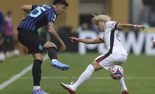 Inter Milan's Alessandro Bastoni, left and Urawa Red Diamonds' Yusuke Matsuo vie for the ball during the Club World Cup Group E soccer match between Inter Milan and Urawa Red Diamonds in Seattle, Saturday, June 21, 2025. (AP Photo/Ryan Sun)