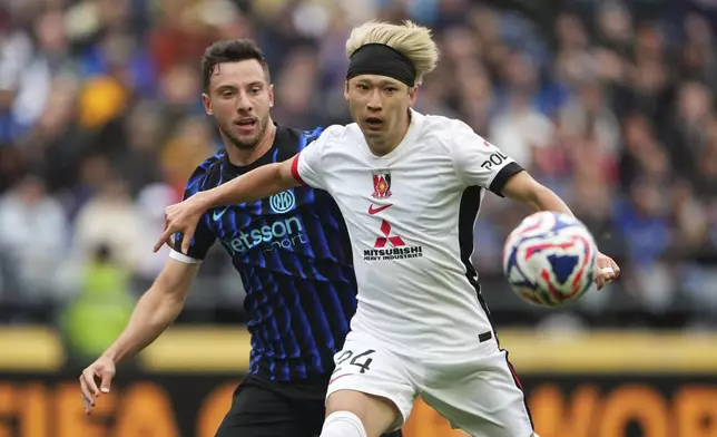 Inter Milan's Carlos Augusto and Urawa Red Diamonds' Yusuke Matsuo battle during the Club World Cup Group E soccer match between Inter Milan and Urawa Red Diamonds in Seattle, Saturday, June 21, 2025. (AP Photo/Lindsey Wasson)