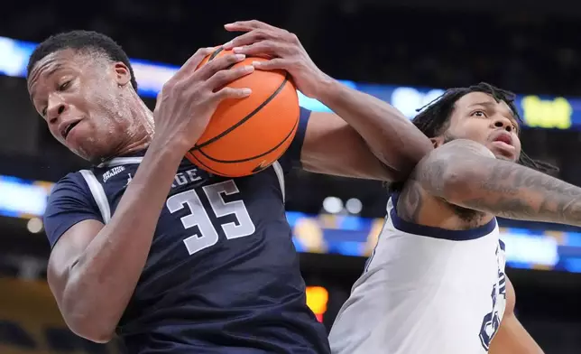 FILE - Marquette's Chase Ross and Georgetown's Thomas Sorber battle for a loose ball during the first half of an NCAA college basketball game Tuesday, Jan. 7, 2025, in Milwaukee. (AP Photo/Morry Gash, File)
