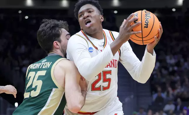 FILE - Maryland center Derik Queen, right, drives against Colorado State guard Ethan Morton during the first half in the second round of the NCAA college basketball tournament, Sunday, March 23, 2025, in Seattle. (AP Photo/Ryan Sun, File)