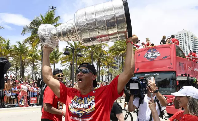 Florida Panthers Brad Marchand walks the parade route with the Stanley Cup trophy during the Panthers 2025 Championship Celebration, Sunday, June 20, 2022, in Fort Lauderdale, Fla. (AP Photo/Michael Laughlin)