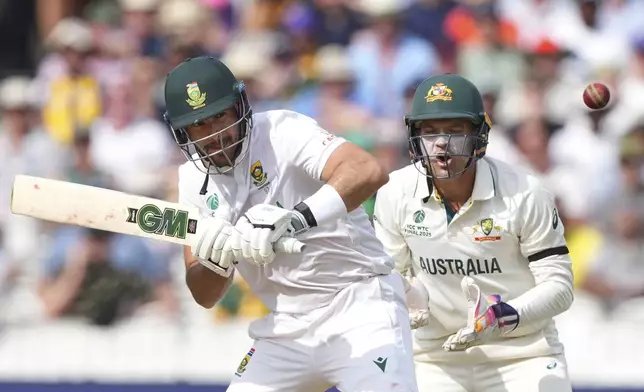 Australia's wicketkeeper Alex Carey, right, reacts as South Africa's Aiden Markram plays a shot on day three of the World Test Championship final between South Africa and Australia at Lord's cricket ground in London, Friday, June 13, 2025. (AP Photo/Kirsty Wigglesworth)