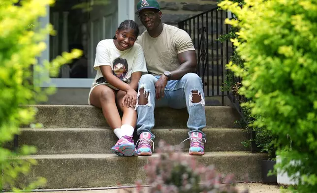 Evan Polk and his daughter, Jordyn Polk, 13, sit for a portrait in Secane, Pa., Thursday, June 5, 2025. (AP Photo/Matt Slocum)