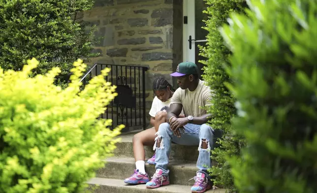Evan Polk, right, talks with his daughter, Jordyn Polk, 13, after she was dropped off from school in Secane, Pa., Thursday, June 5, 2025. (AP Photo/Matt Slocum)