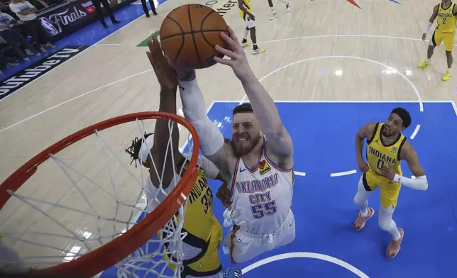 Oklahoma City Thunder center Isaiah Hartenstein (55) dunks over Indiana Pacers center Myles Turner (33) during the second half of Game 5 of the NBA Finals basketball series, Monday, June 16, 2025, in Indianapolis. (Matthew Stockman/Pool Photo via AP)