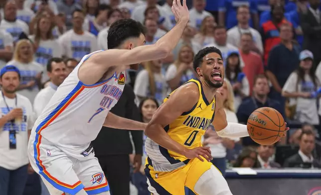 Indiana Pacers guard Tyrese Haliburton (0) drives past Oklahoma City Thunder forward Chet Holmgren (7) during the second half of Game 5 of the NBA Finals basketball series, Monday, June 16, 2025, in Oklahoma City. (AP Photo/Kyle Phillips)