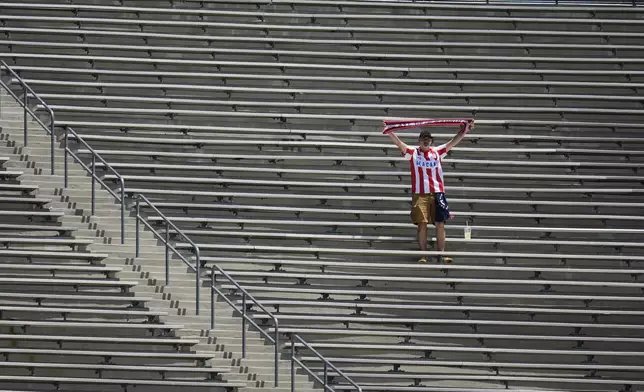 A fan from Atletico Madrid cheers prior to the Club World Cup Group B soccer match between Atletico Madrid and Botafogo in Pasadena, Calif., Monday, June 23, 2025. (AP Photo/Greg Bull)