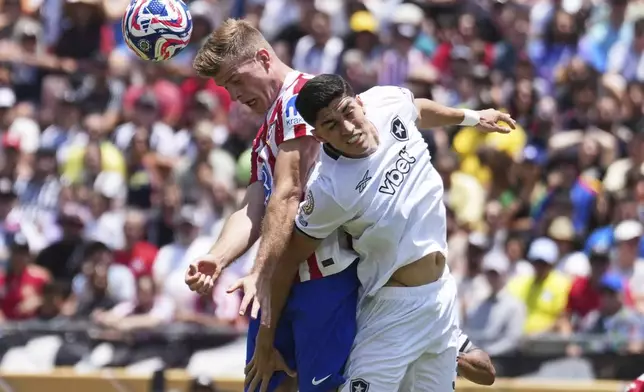 Atletico Madrid's Alexander Sorloth, back, heads a ball challenged by Botafogo's Jair Cunha during the Club World Cup Group B soccer match between Atletico Madrid and Botafogo in Pasadena, Calif., Monday, June 23, 2025. (AP Photo/Jae Hong)