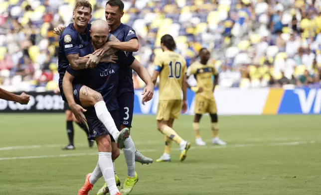 Auckland City's Christian Gray, center, celebrates after scoring his side's opening goal with teammates during the Club World Cup Group C soccer match between Auckland City and Boca Juniors in Nashville, Tenn., Tuesday, June 24, 2025. (AP Photo/Johnnie Izquierdo)