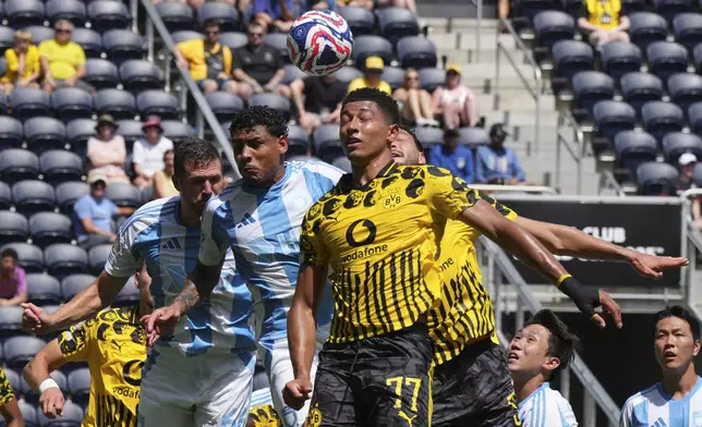 Borussia Dortmund's Jobe Bellingham, foreground, jumps for the ball with other players during the Club World Cup Group F soccer match between Borussia Dortmund and Ulsan in Cincinnati, Wednesday, June 25, 2025. (AP Photo/Jeff Dean)