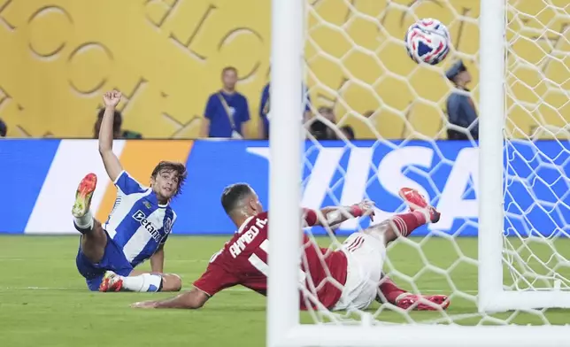Porto's Rodrigo Mora, left, reacts as he kicks the ball past Al Ahly's Ahmed Ramadan to score his team's first goal during the Club World Cup Group A soccer match between FC Porto and Al Ahly in East Rutherford, N.J., Monday, June 23, 2025. (AP Photo/Frank Franklin II)
