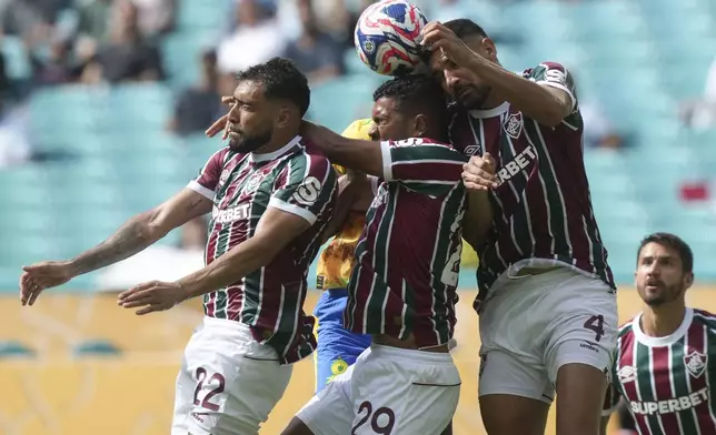 Fluminense's Juan Pablo Freytes, left, Thiago Santos, center and Ignacio go up for the ball during the Club World Cup Group F soccer match between Mamelodi Sundowns and Fluminense in Miami Gardens, Fla., Wednesday, June 25, 2025. (AP Photo/Marta Lavandier)