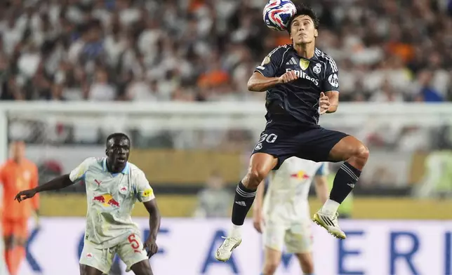 Real Madrid's Gonzalo Garcia, right, heads the ball as Red Bull Salzburg's Soumaila Diabate, left, watches during the Club World Cup Group H soccer match between Salzburg and Real Madrid in Philadelphia, Thursday, June 26, 2025. (AP Photo/Matt Slocum)