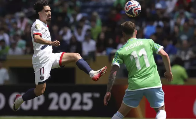 Paris Saint-Germain's Vitinha, left, controls the ball as Seattle Sounders' Albert Rusnak defends during the Club World Cup Group B soccer match between Seattle Sounders and PSG in Seattle, Monday, June 23, 2025. (AP Photo/Ryan Sun)