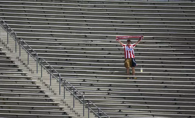 A fan from Atletico Madrid cheers prior to the Club World Cup Group B soccer match between Atletico Madrid and Botafogo in Pasadena, Calif., Monday, June 23, 2025. (AP Photo/Greg Bull)