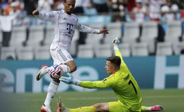 Benfica's Anatoliy Trubin saves in front of Bayern Munich's Leroy Sane during the Club World Cup Group C soccer match between Benfica and Bayern Munich in Charlotte, N.C., Tuesday, June 24, 2025. (AP Photo/Nell Redmond)