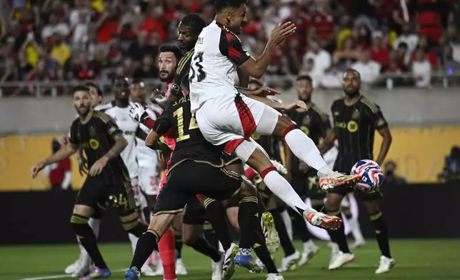 Flamengo's Danilo, front, attempts a shot on goal during the Club World Cup Group D soccer match between Los Angeles FC and Flamengo in Orlando, Fla., Tuesday, June 24, 2025. (AP Photo/Phelan Ebenhack)