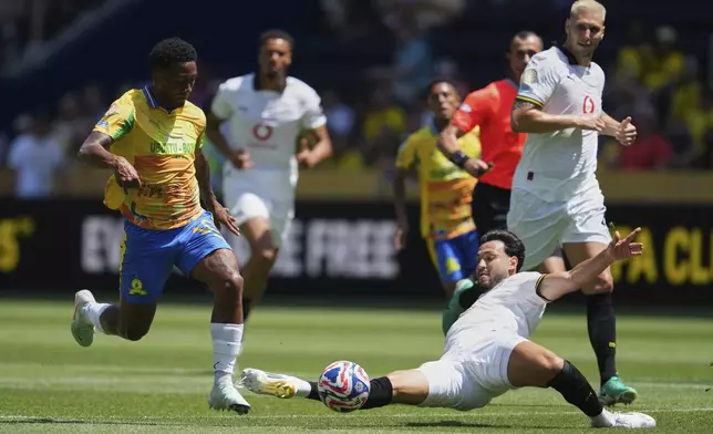 Borussia Dortmund's Ramy Bensebaini tries to tackle Mamelodi Sundowns' Lucas Ribeiro Costa during the Club World Cup Group F soccer match between Mamelodi Sundowns and Borussia Dortmund in Cincinnati, Saturday, June 21, 2025. (AP Photo/Jeff Dean)
