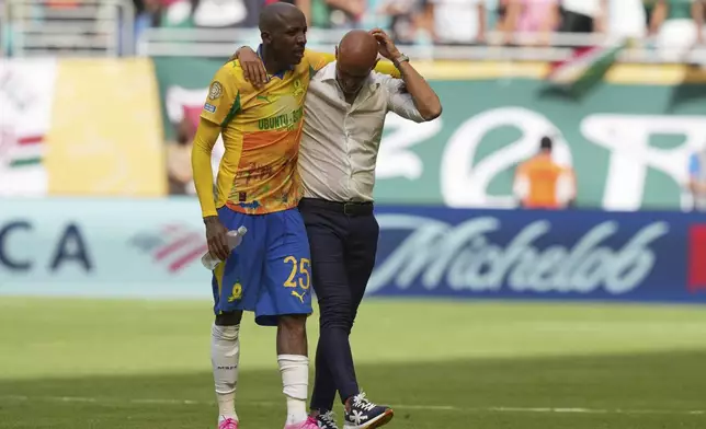 Mamelodi Sundowns' Khuliso Mudau and his coach Miguel Cardoso leaves the pitch after the Club World Cup Group F soccer match between Mamelodi Sundowns and Fluminense in Miami Gardens, Fla., Wednesday, June 25, 2025. (AP Photo/Lynne Sladky)