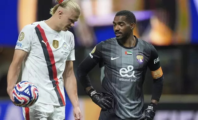 Manchester City's Erling Haaland talks with Al Ain's goalkeeper Khalid Eisa during the Club World Cup Group G soccer match between Manchester City and Al Ain in Atlanta, Sunday, June 22, 2025. (AP Photo/Mike Stewart)