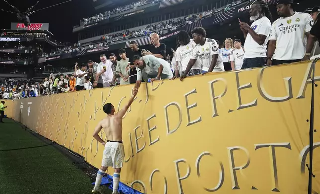 Red Bull Salzburg's Oscar Gloukh shakes hands with a fan following the Club World Cup Group H soccer match between Salzburg and Real Madrid in Philadelphia, Thursday, June 26, 2025. (AP Photo/Matt Slocum)