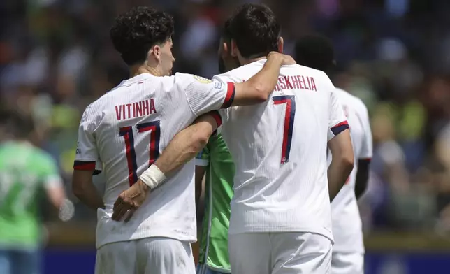 Paris Saint-Germain's Khvicha Kvaratskhelia, right, celebrates after scoring his side's first goal during the Club World Cup Group B soccer match between Seattle Sounders and PSG in Seattle, Monday, June 23, 2025. (AP Photo/Ryan Sun)
