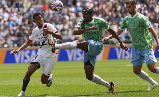 Paris Saint-Germain's Senny Mayulu kicks the ball away from Seattle Sounders' Jon Bell during the Club World Cup Group B soccer match between Seattle Sounders and PSG in Seattle, Monday, June 23, 2025. (AP Photo/Lindsey Wasson)