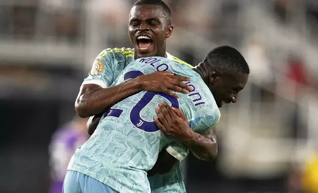 Juventus' Randal Kolo Muani is congratulated by Juventus' Pierre Kalulu after scoring his side's fourth goal during the Club World Cup group G soccer match between Al Ain and Juventus in Washington, Wednesday, June 18, 2025. (AP Photo/Julia Demaree Nikhinson)
