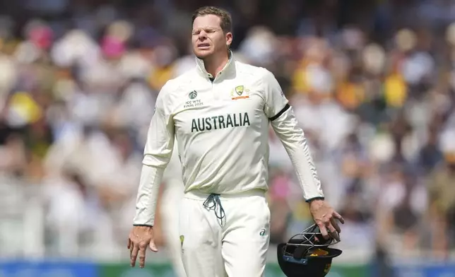 Australia's Steve Smith reacts after getting hurt while fielding on day three of the World Test Championship final between South Africa and Australia at Lord's cricket ground in London, Friday, June 13, 2025. (AP Photo/Kirsty Wigglesworth)