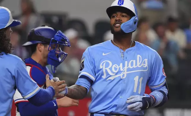 Kansas City Royals' Maikel Garcia celebrates his home run that scored teammates Jonathan India and Bobby Witt Jr. during the fourth inning of a baseball game against the Texas Rangers, Wednesday, June 18, 2025, in Arlington, Texas. (AP Photo/LM Otero)