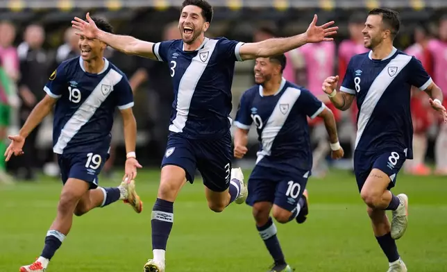 Guatemala defender Nicolás Samayoa (3) celebrates with teammates after defeating Canada in penalty kicks during a CONCACAF Gold Cup quarterfinals soccer match Sunday, June 29, 2025, in Minneapolis. (AP Photo/Abbie Parr)