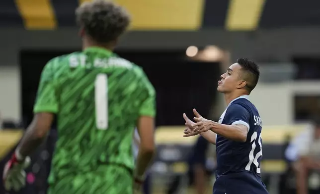 Guatemala midfielder Oscar Santis, right, celebrates near Canada goalkeeper Dayne St. Clair (1) after scoring during a penalty kick shootout of a CONCACAF Gold Cup quarterfinals soccer match Sunday, June 29, 2025, in Minneapolis. (AP Photo/Abbie Parr)