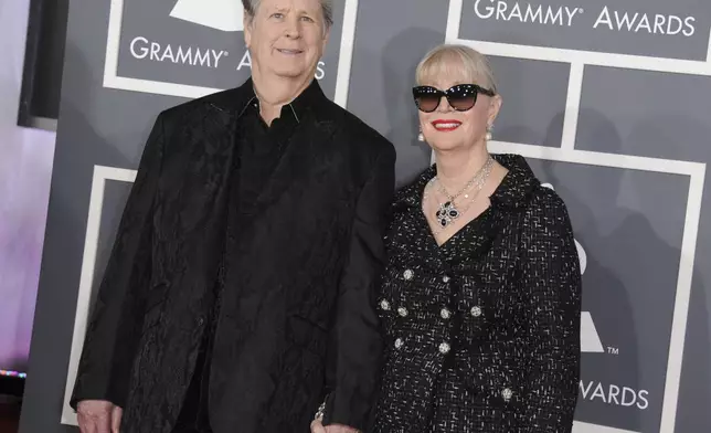 FILE - Musician Brian Wilson, left, and his wife Melinda Ledbetter Wilson arrive at the 55th annual Grammy Awards on Sunday, Feb. 10, 2013, in Los Angeles. (Photo by Jordan Strauss/Invision/AP, File)