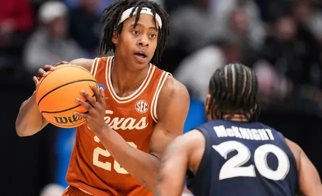 FILE - Texas guard Tre Johnson (20) controls the ball against Xavier guard Dayvion McKnight (20) during a First Four college basketball game in the NCAA Tournament, Wednesday, March 19, 2025, in Dayton, Ohio. (AP Photo/Jeff Dean, File)