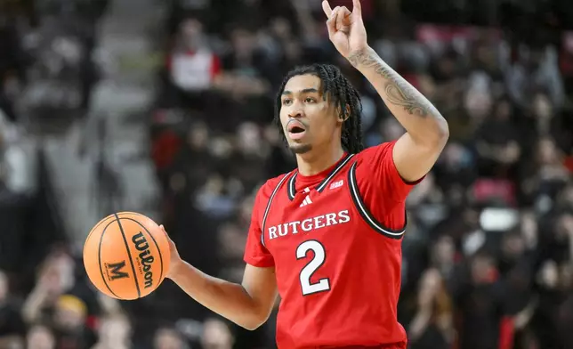 FILE - Rutgers guard Dylan Harper (2) handles the ball during the first half of an NCAA college basketball game against Maryland, Sunday, Feb. 9, 2025, in College Park, Md. (AP Photo/Terrance Williams, File)