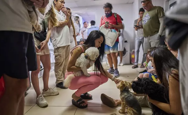 People take shelter in a basement in Tel Aviv, Israel, during an alarm of incoming missiles from Iran, Monday, June 23, 2025. (AP Photo/Bernat Armangue)