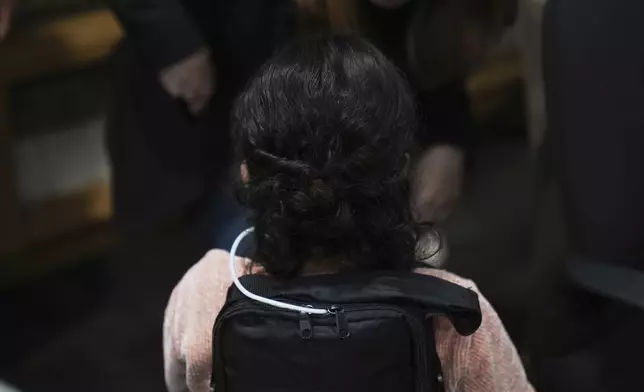 A 4-year-old Mexican girl, who has short bowel syndrome, wears a backpack carrying her medical device at a news conference in Los Angeles, Wednesday, May 28, 2025, after her and her mother's humanitarian parole was terminated and they were ordered to self-deport. (AP Photo/Jae C. Hong)