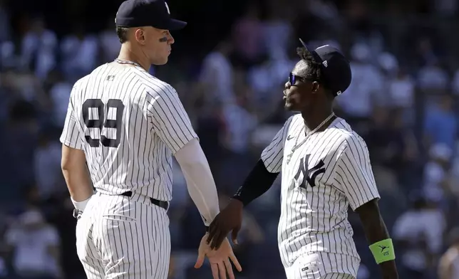 New York Yankees' Aaron Judge (99) and Jazz Chisholm Jr., right, celebrate after they defeated the Athletics in a baseball game Sunday, June 29, 2025, in New York. (AP Photo/Adam Hunger)