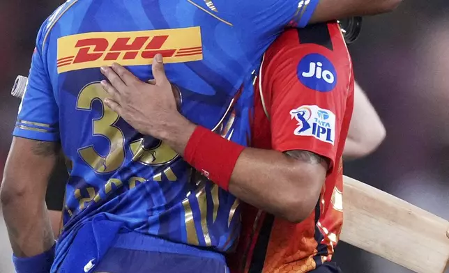 Mumbai Indians' captain Hardik Pandya, left, congratulates Punjab Kings' captain Shreyas Iyer on winning the Indian Premier League cricket match at Narendra Modi Stadium in Ahmedabad, India, Monday, June 2, 2025. (AP Photo/Ajit Solanki)