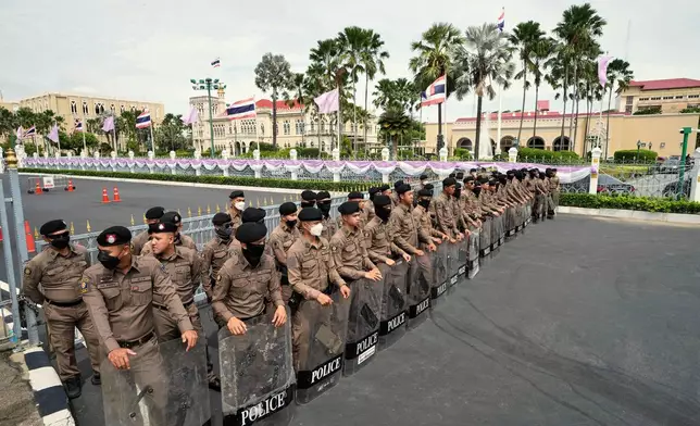 Thai policemen hold shields as anti-government protesters gather in front of Government house demanding Thailand's Prime Minister Paetongtarn Shinawatra resign in Bangkok, Thailand, Thursday, June 19, 2025, (AP Photo/Sakchai Lalit)